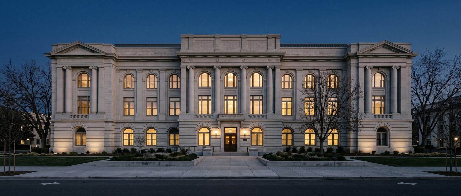The Sacramento County courthouse at dusk with warmly lit windows
