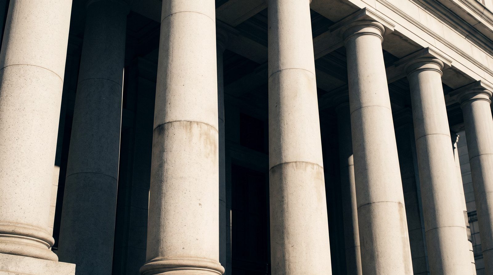 Granite courthouse columns in strong morning light